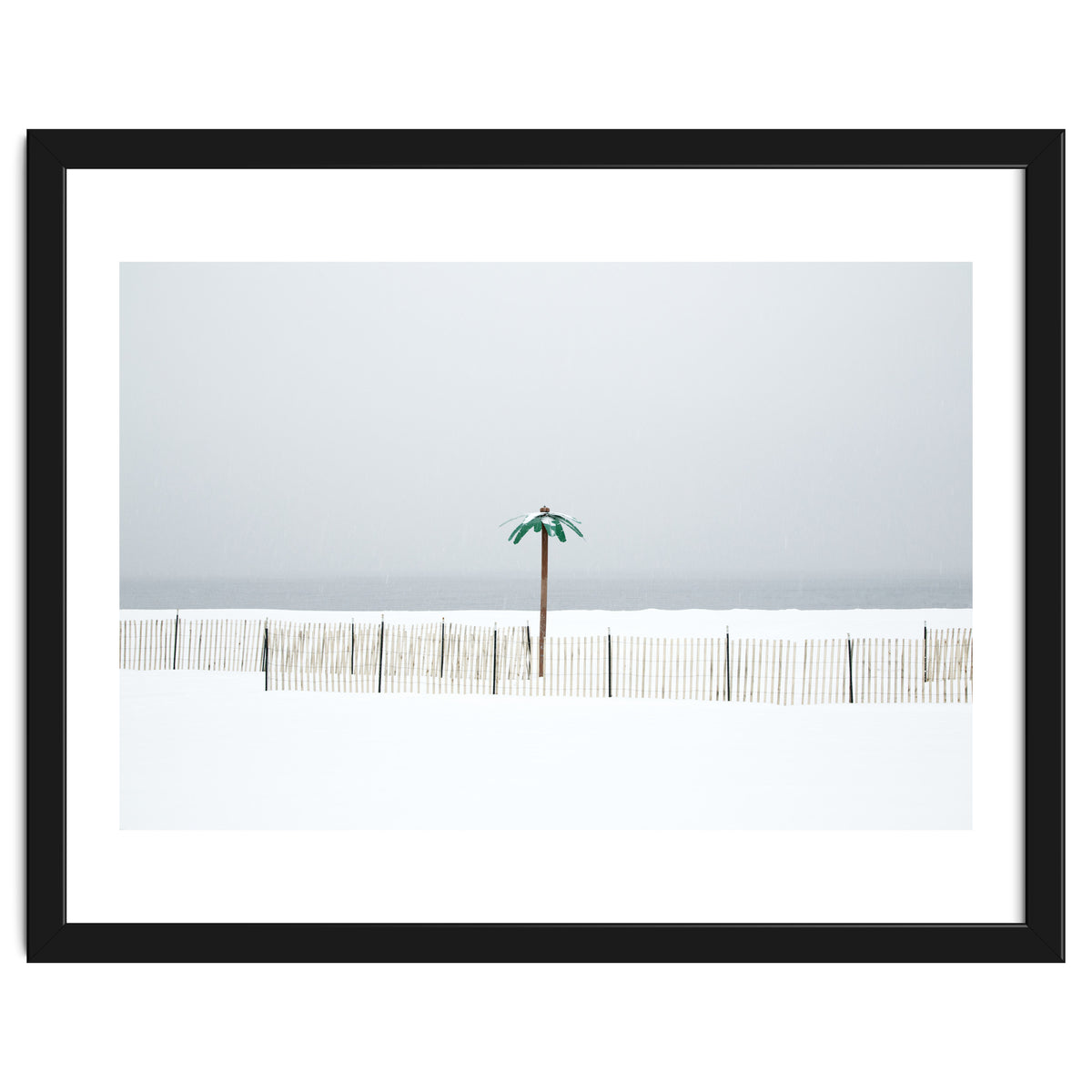 Fake palm tree in the winter snow beach