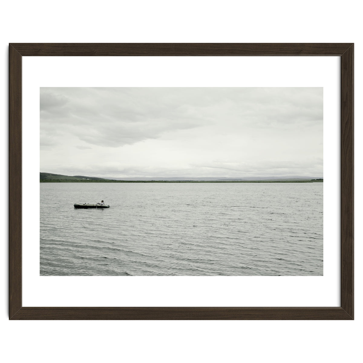A boy pedaling the Board on the Lake - Iceland