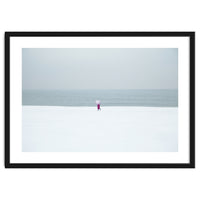 A walking woman in the winter snow beach