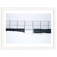 The entrance gate of the snow-covered baseball field