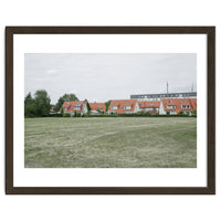 Red roof houses in the green field