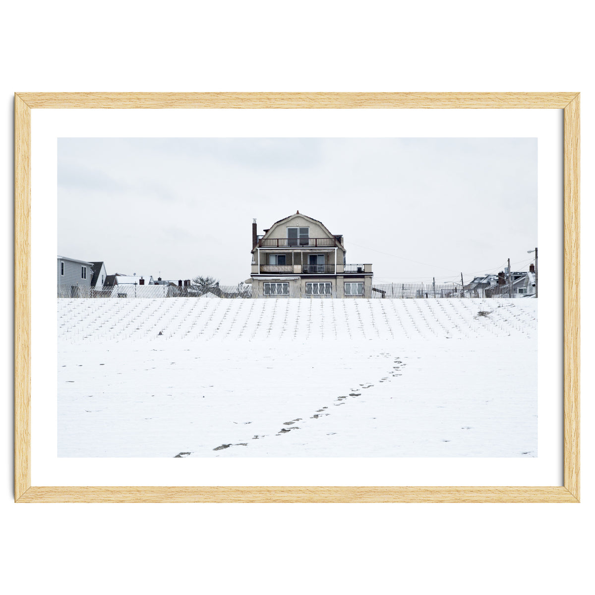 Footprints and house in winter snowscape