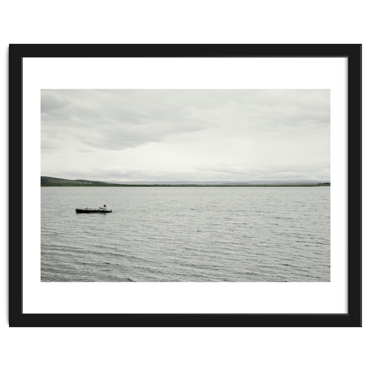 A boy pedaling the Board on the Lake - Iceland