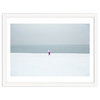 A walking woman in the winter snow beach