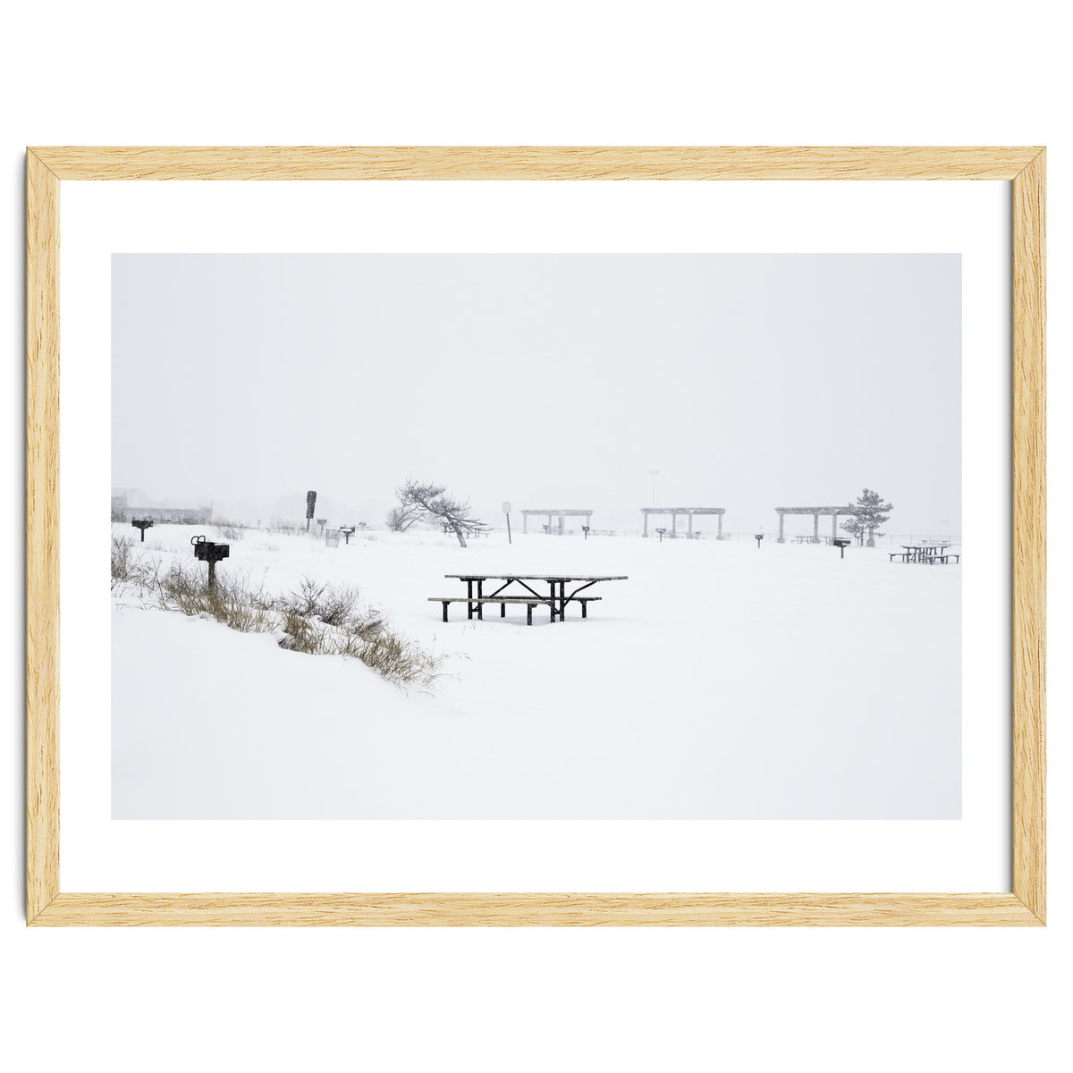 Tables and benches in a snow-covered park