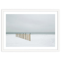 Wood fence in the winter snow beach