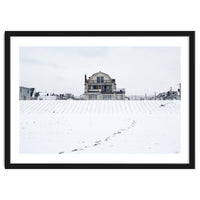 Footprints and house in winter snowscape