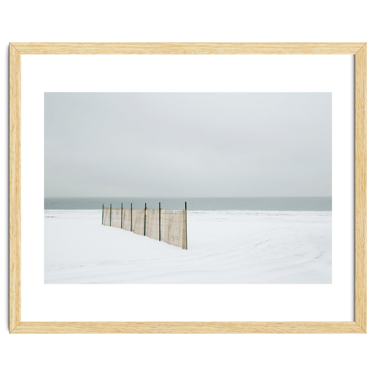 Wood fence in the winter snow beach