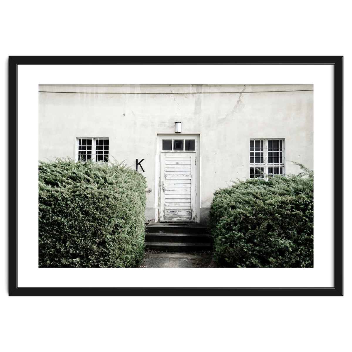 White door K between the green botanical gate