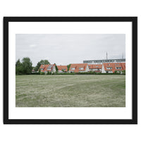 Red roof houses in the green field