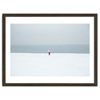 A walking woman in the winter snow beach