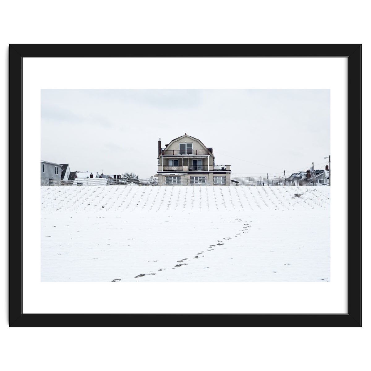 Footprints and house in winter snowscape