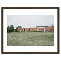 Red roof houses in the green field