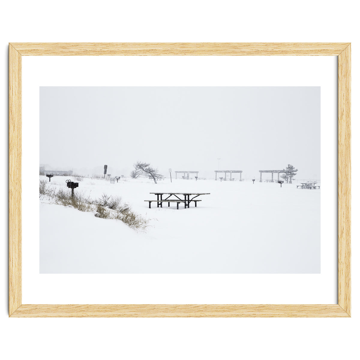 Tables and benches in a snow-covered park