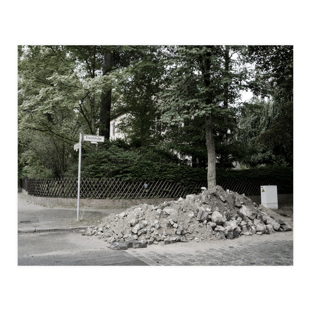 Piled-up rocks under construction on the street (Print Only)
