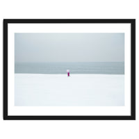 A walking woman in the winter snow beach