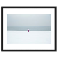 A walking woman in the winter snow beach