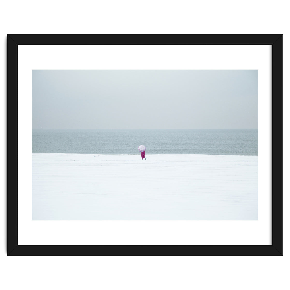 A walking woman in the winter snow beach