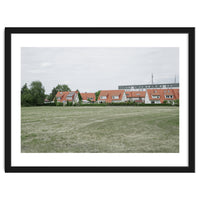 Red roof houses in the green field