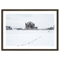 Footprints and house in winter snowscape