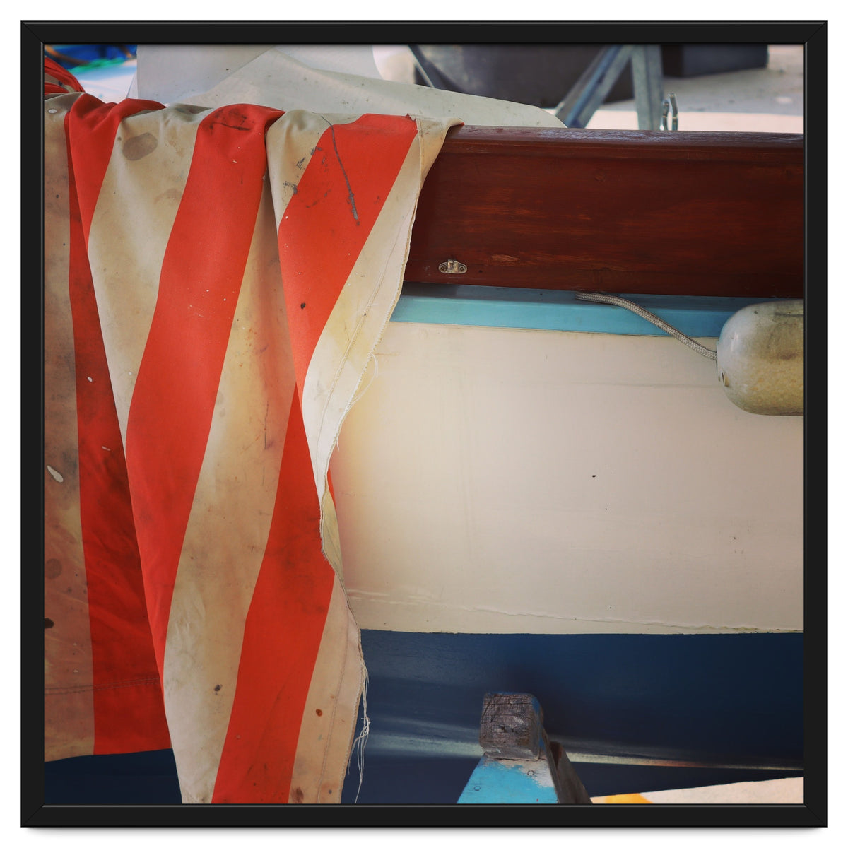 Fishing boat and striped sail