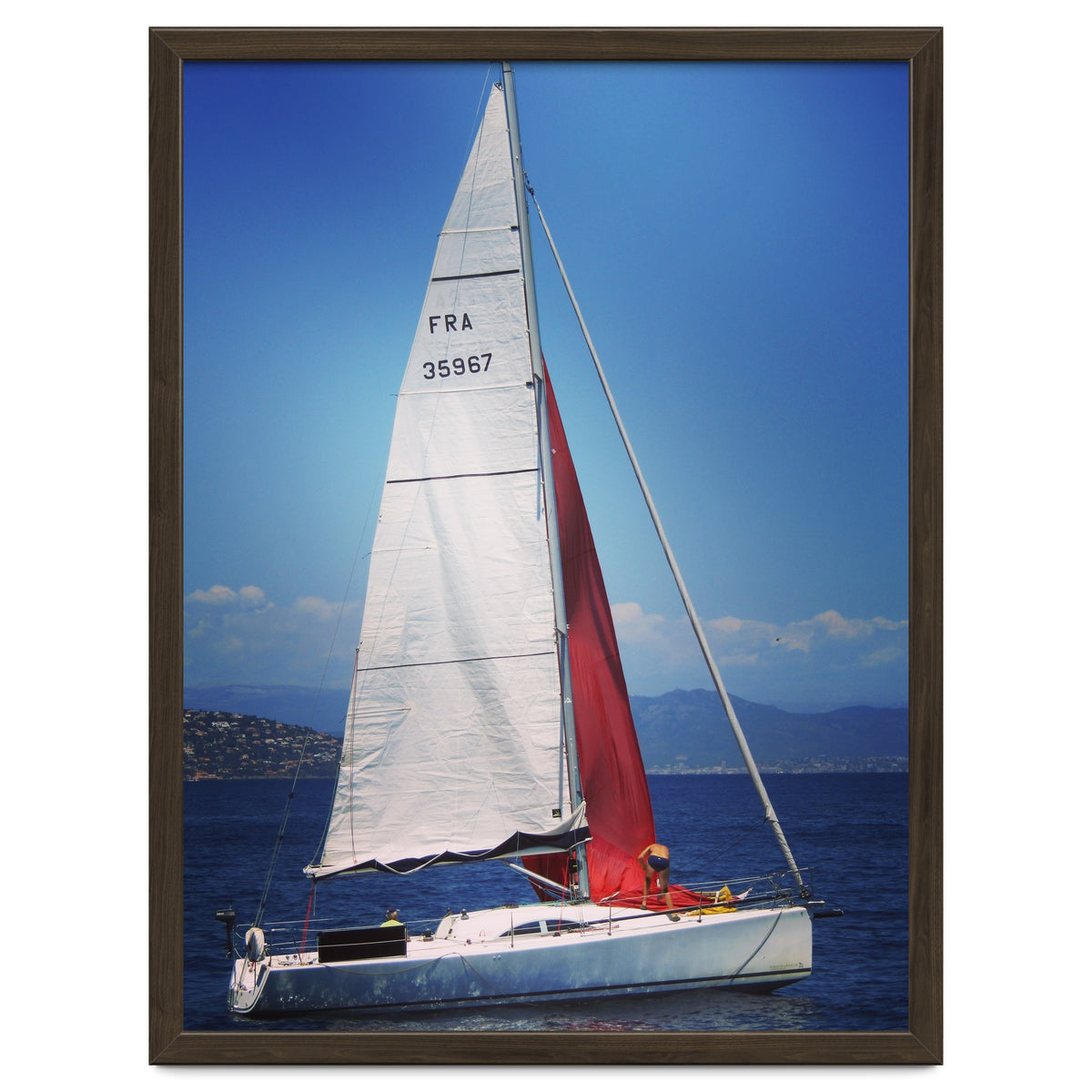Sailing yacht with white and red sails