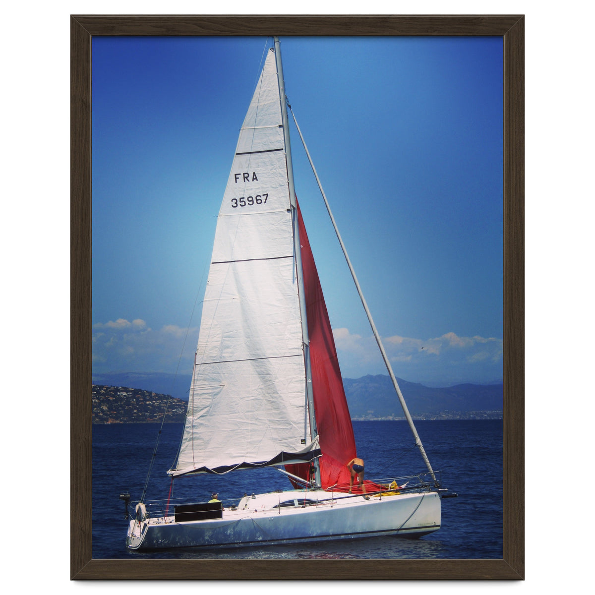 Sailing yacht with white and red sails