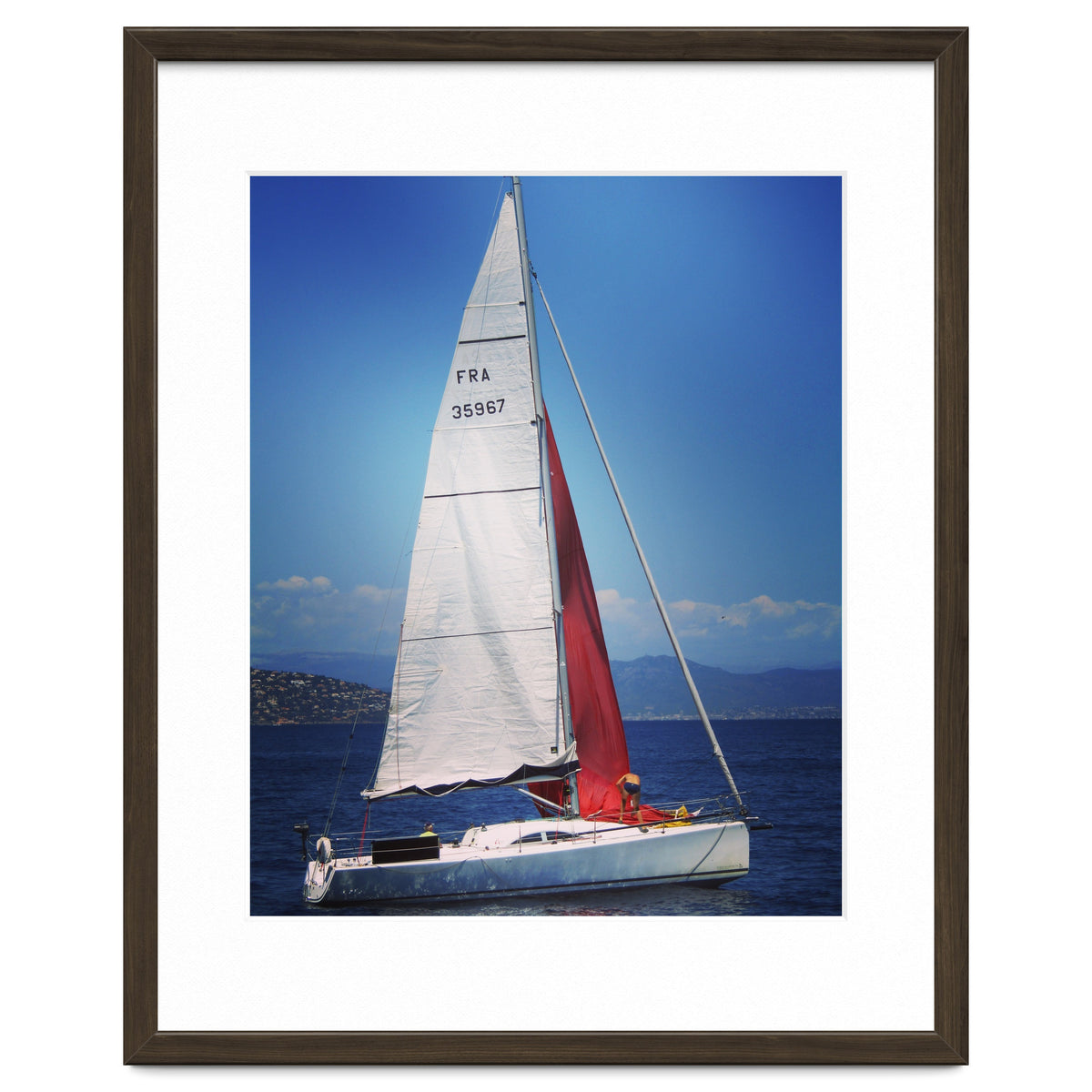 Sailing yacht with white and red sails