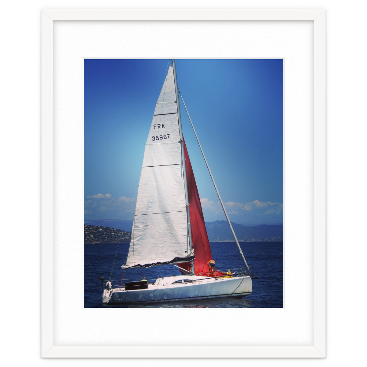 Sailing yacht with white and red sails