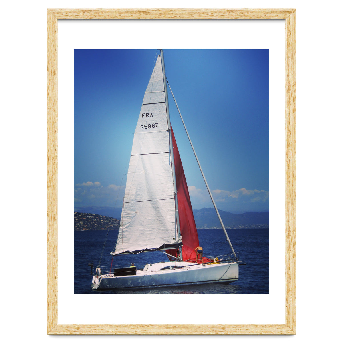 Sailing yacht with white and red sails