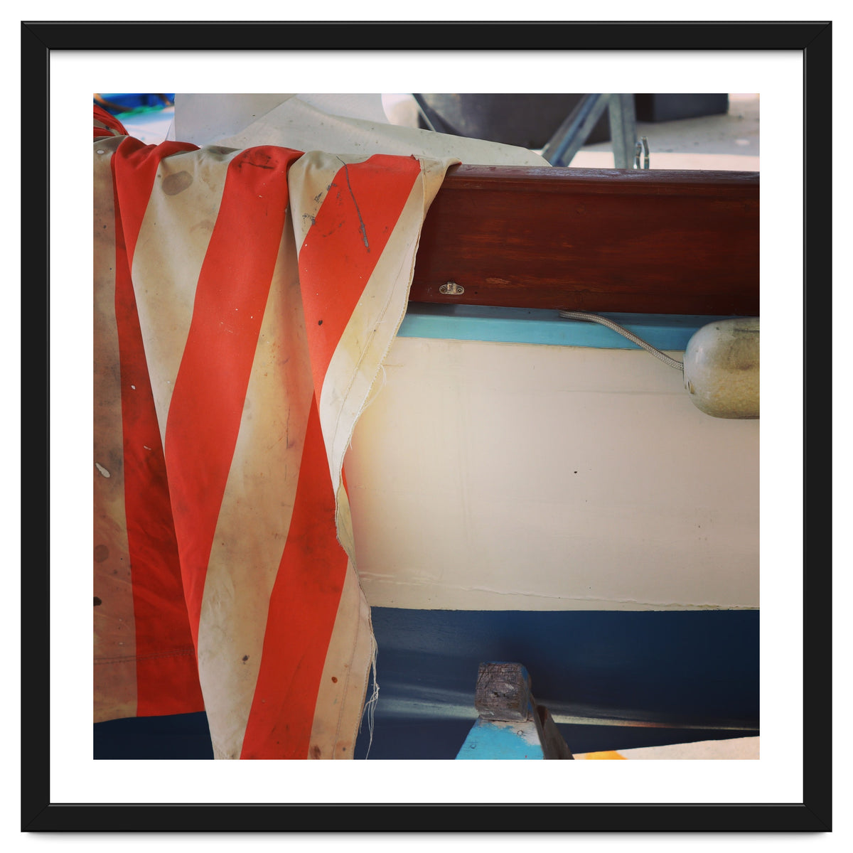 Fishing boat and striped sail