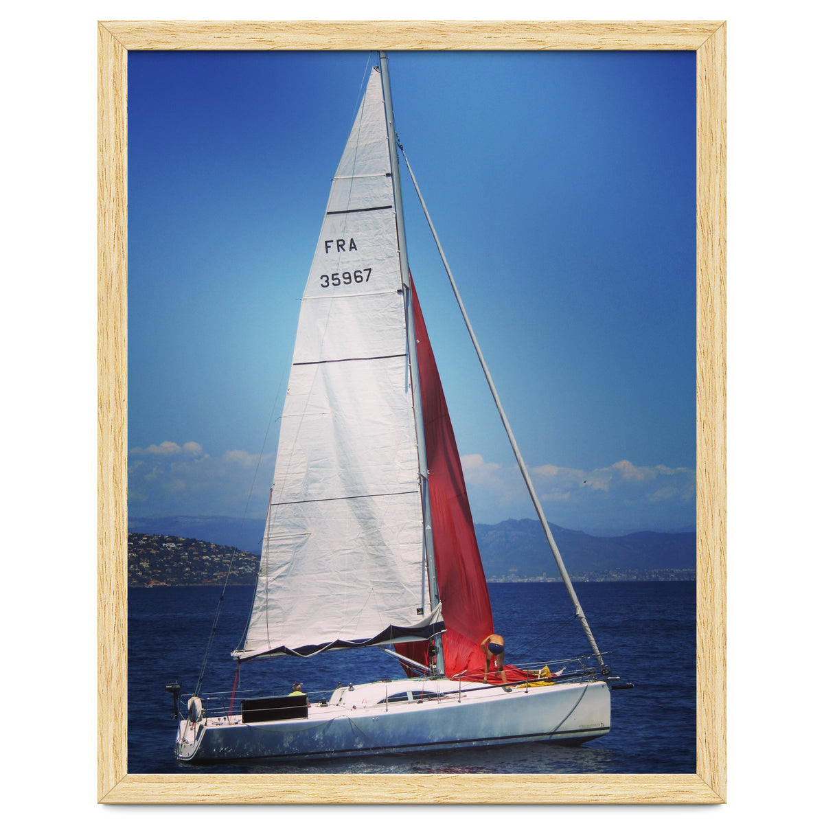 Sailing yacht with white and red sails