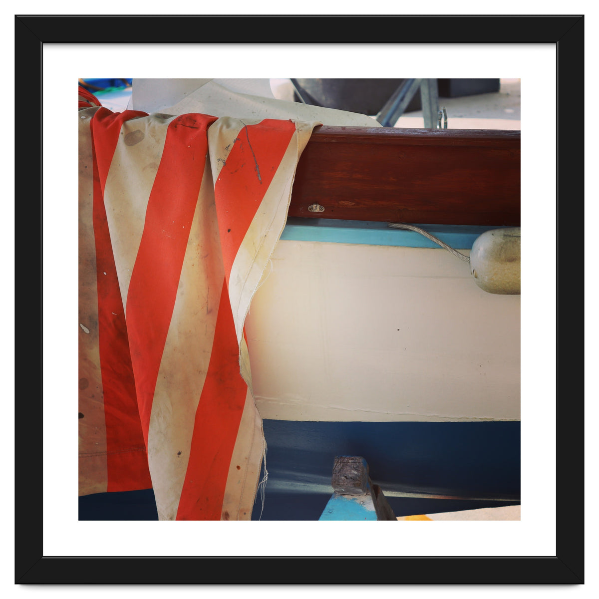 Fishing boat and striped sail