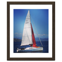 Sailing yacht with white and red sails