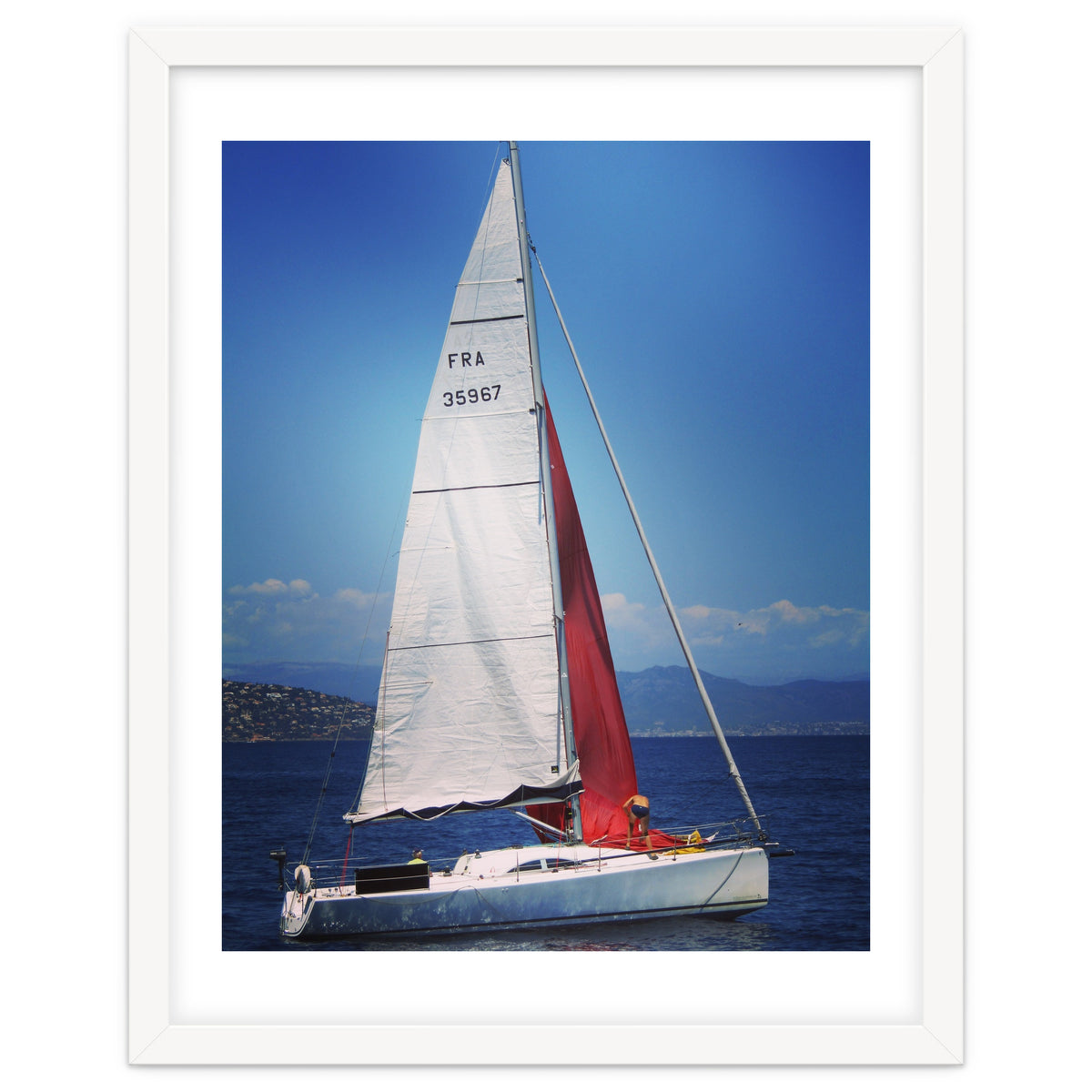 Sailing yacht with white and red sails