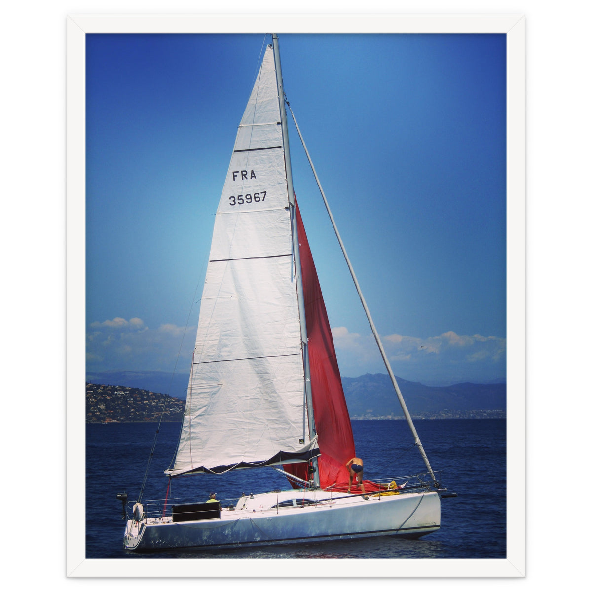 Sailing yacht with white and red sails