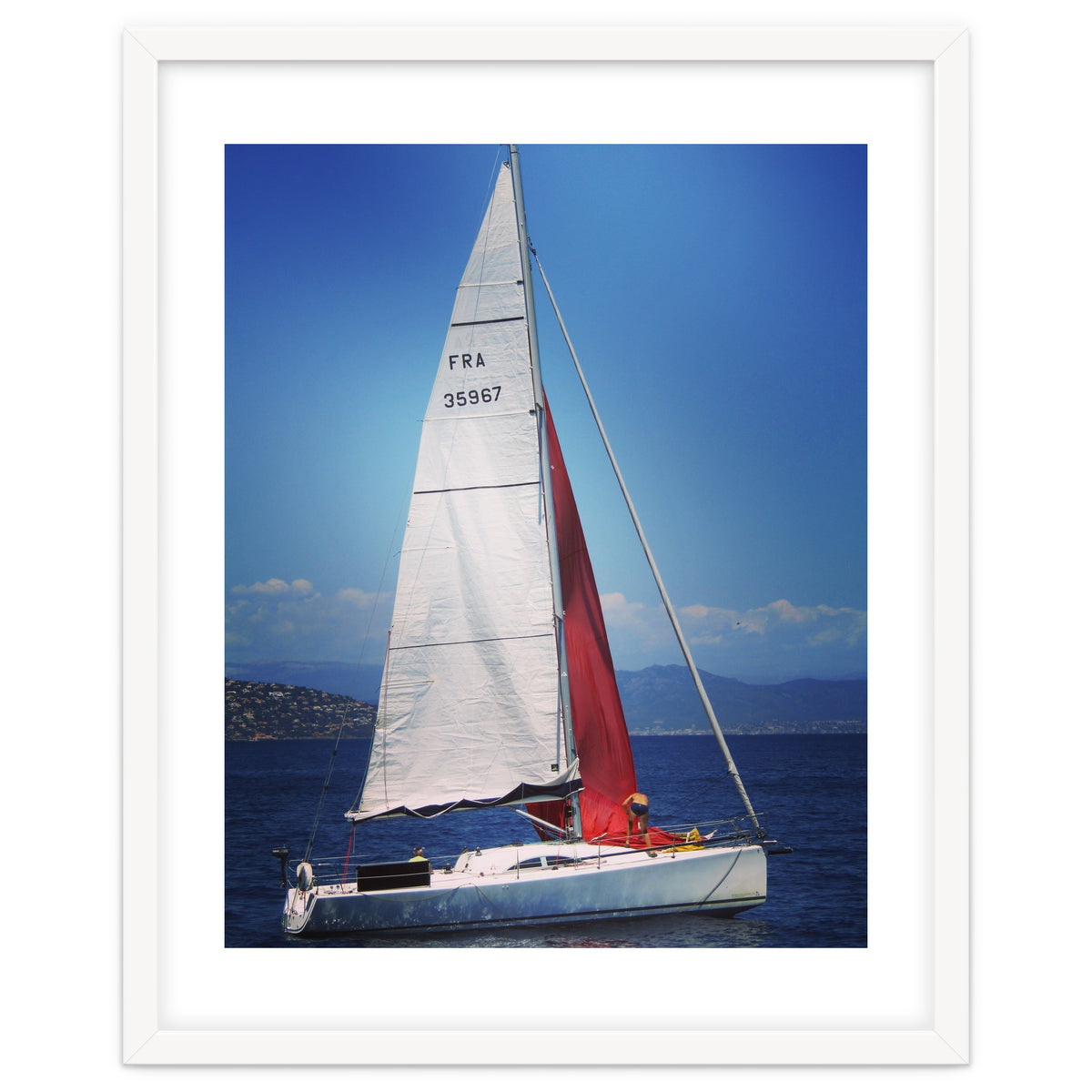 Sailing yacht with white and red sails