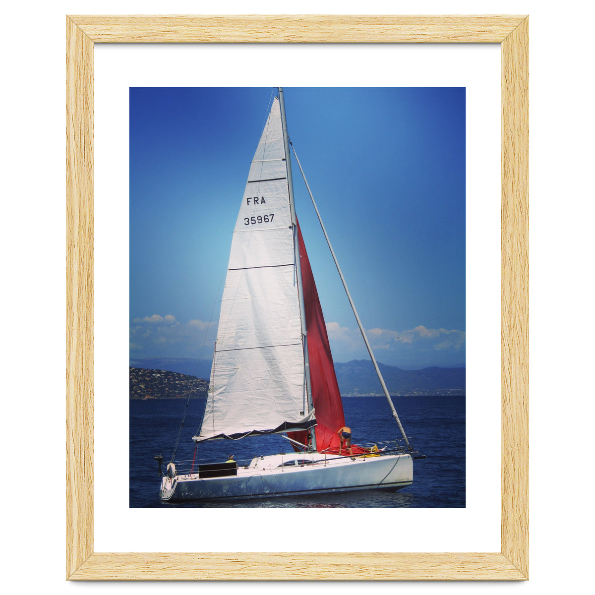 Sailing yacht with white and red sails