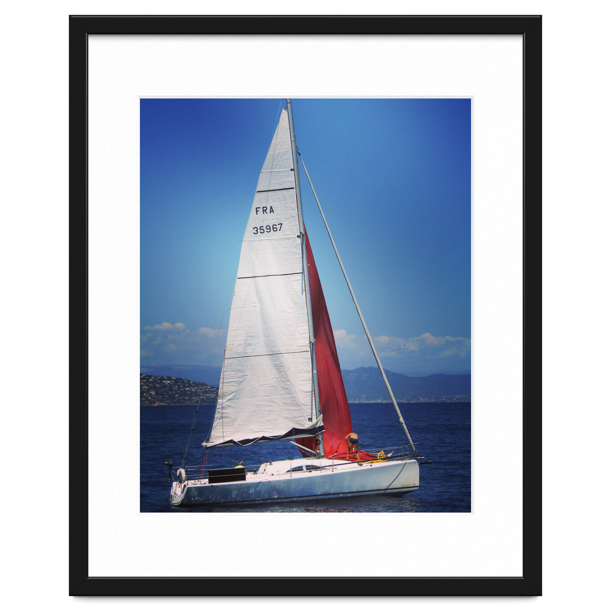 Sailing yacht with white and red sails