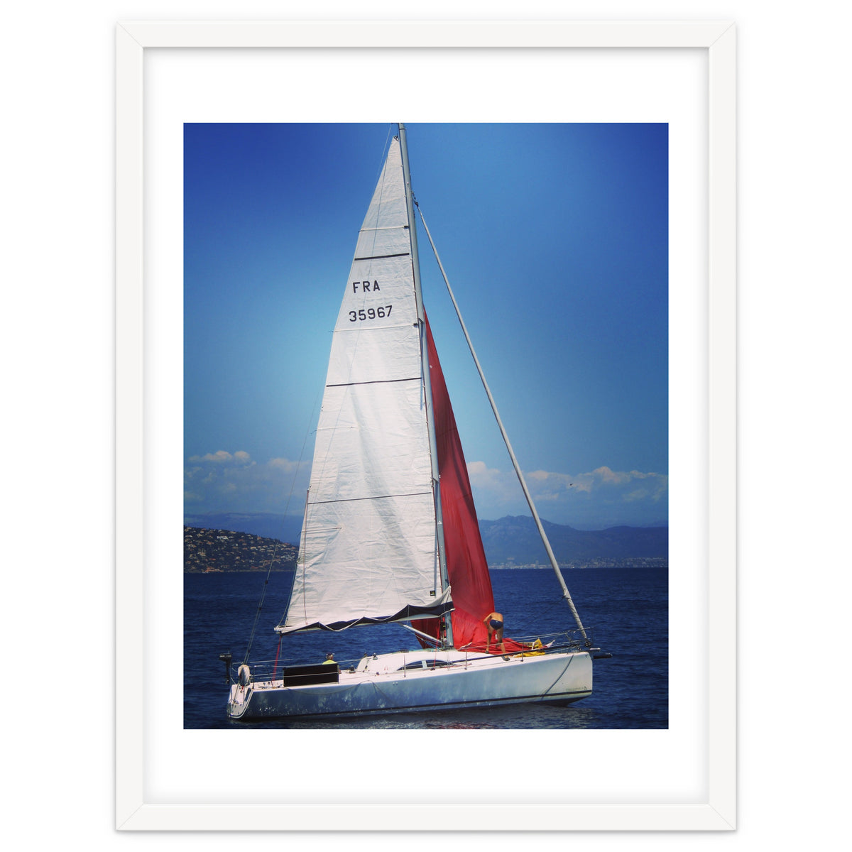 Sailing yacht with white and red sails
