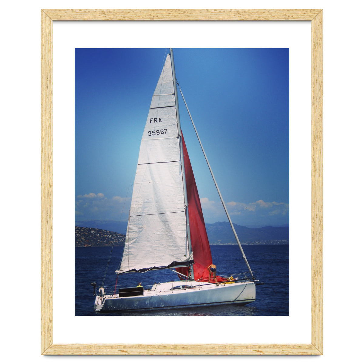 Sailing yacht with white and red sails