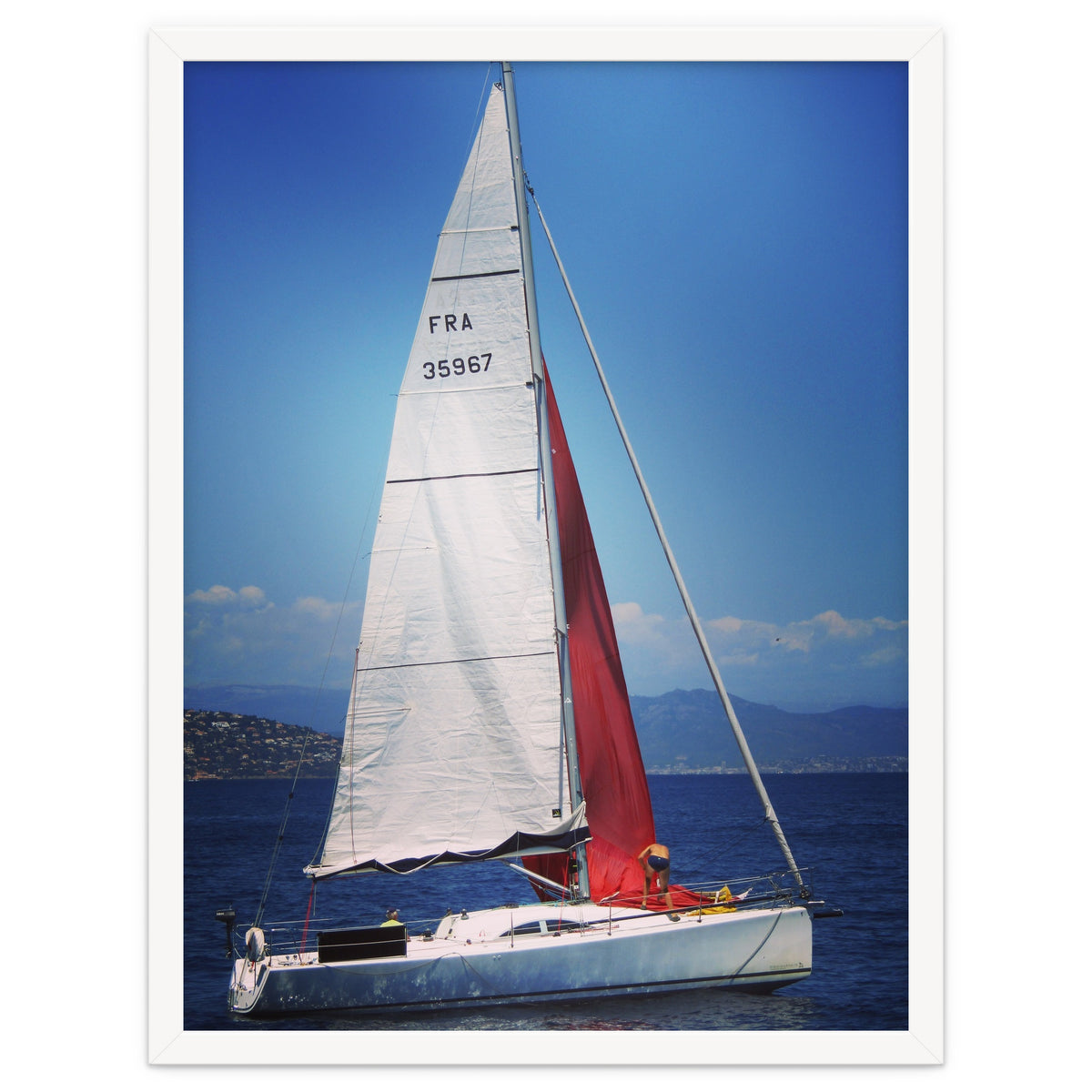Sailing yacht with white and red sails