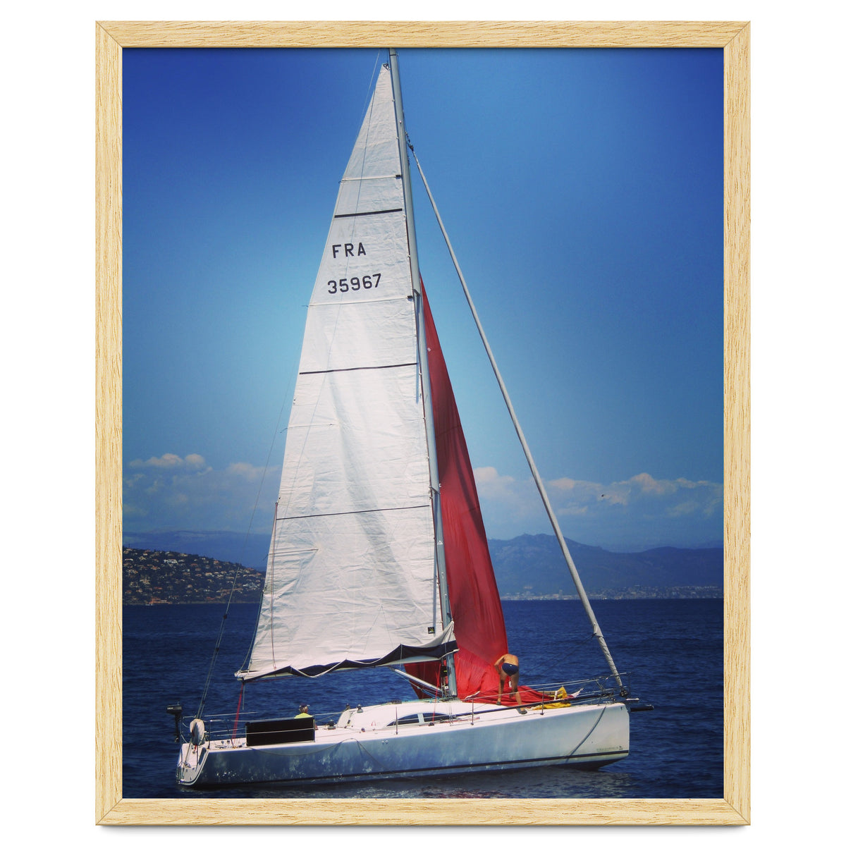 Sailing yacht with white and red sails