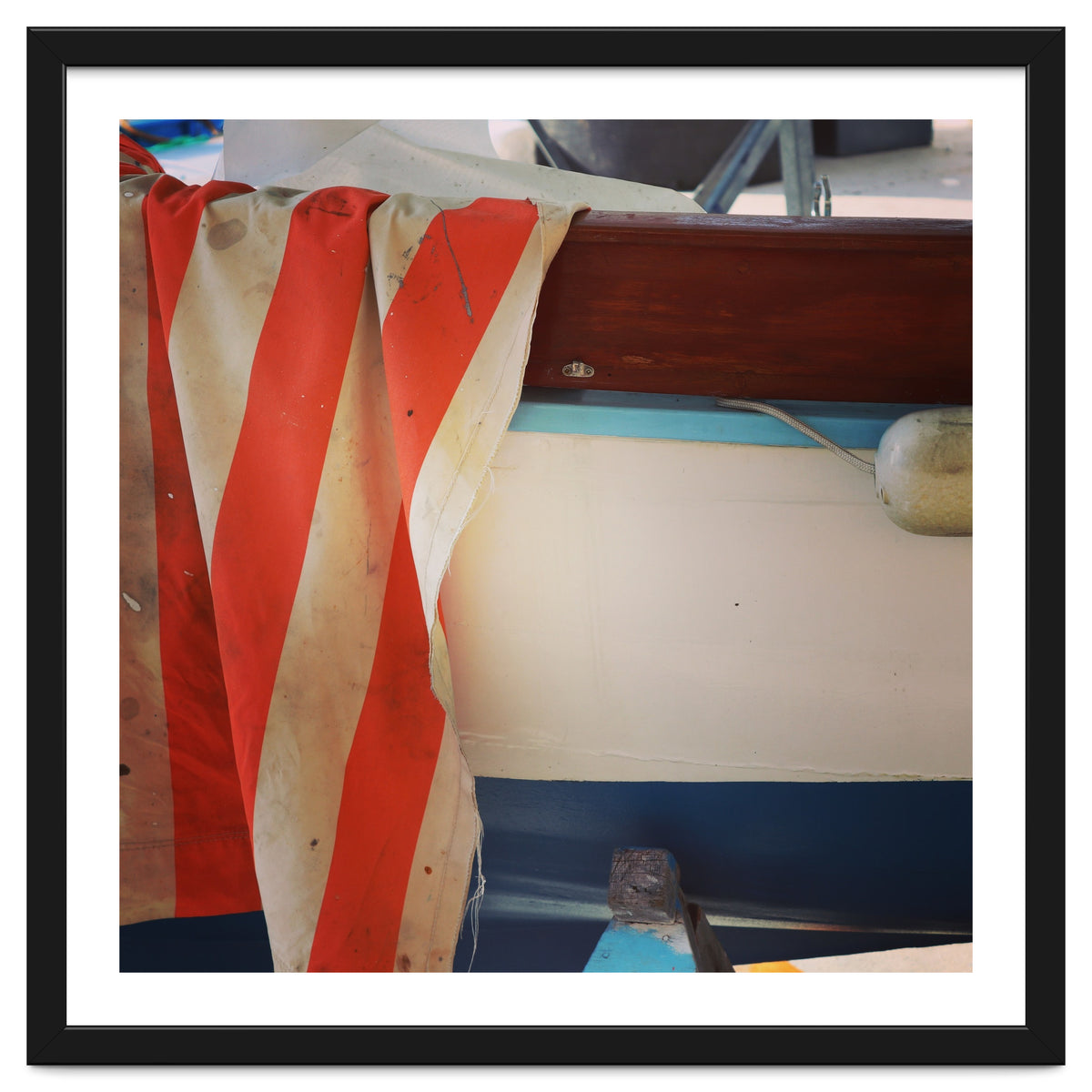 Fishing boat and striped sail