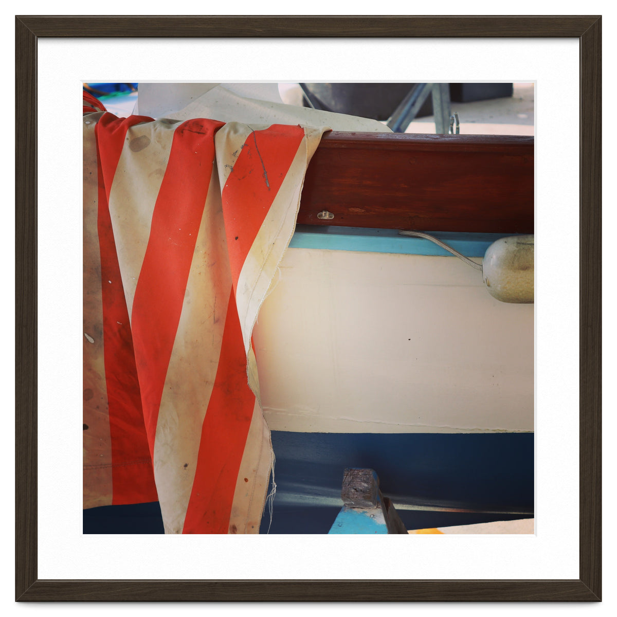 Fishing boat and striped sail