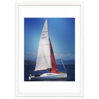 Sailing yacht with white and red sails