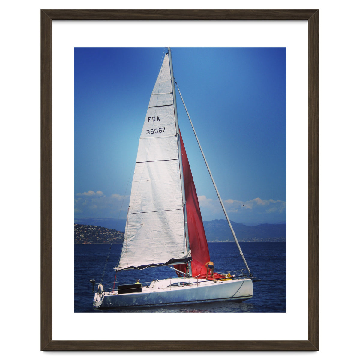 Sailing yacht with white and red sails