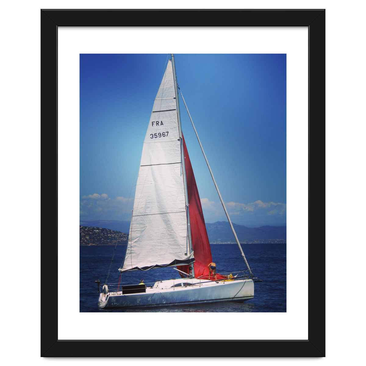 Sailing yacht with white and red sails