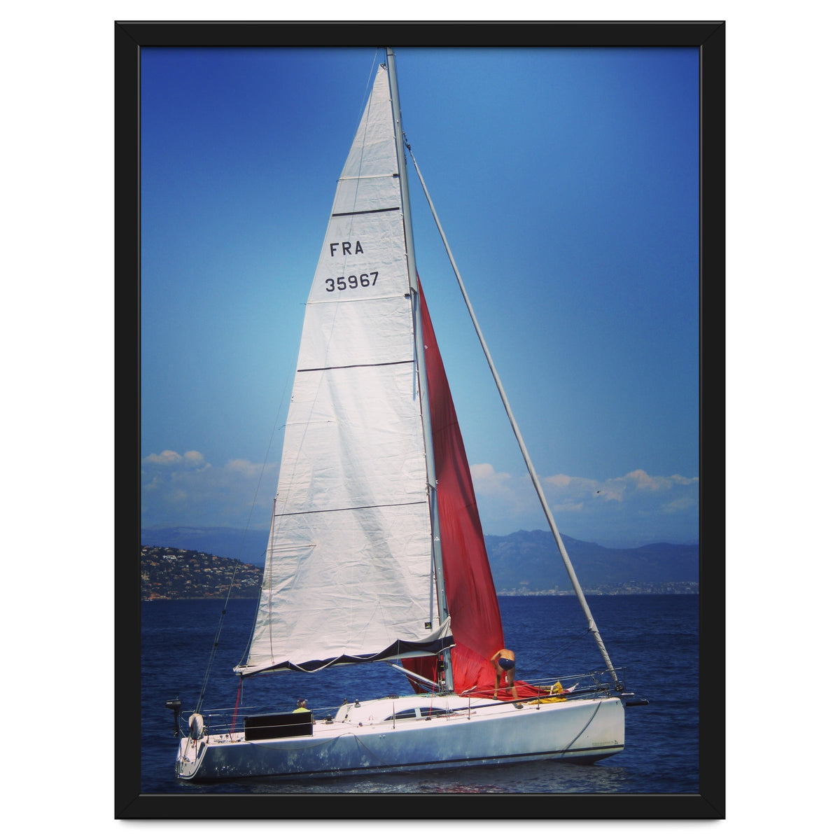 Sailing yacht with white and red sails