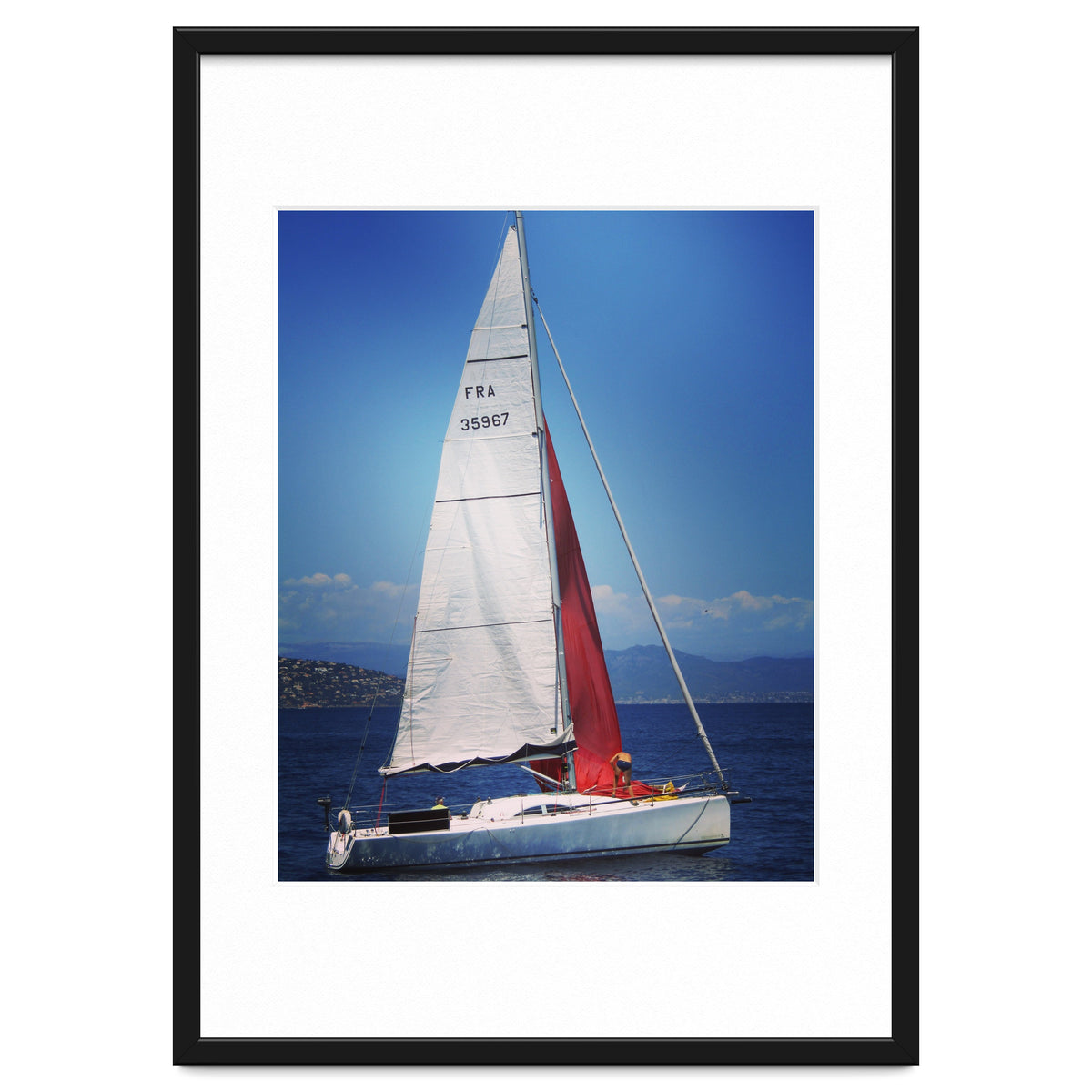 Sailing yacht with white and red sails